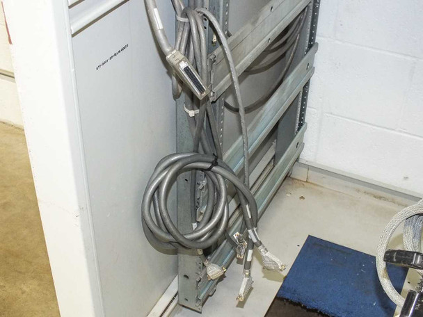 Xicom Technology rack cabinet — interior side wall showing multiple HD-50 / DB-style multi-pin cable assemblies bundled along rail