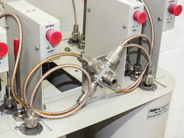 Close-up of ARS 02-CMO-TXCM-101 transmitter combiner assembly with SMA semi-rigid coax cables and TX IN/TX OUT port labels visible