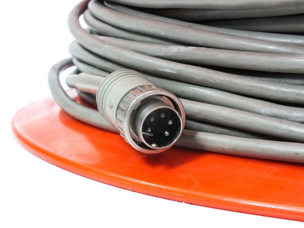 Close-up of 5-pin male circular connector end of gray data extension cable on orange spool