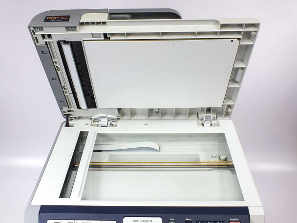 Brother MFC-9440CN — flatbed scanner platen with lid raised showing glass scanning surface and ADF paper feed mechanism