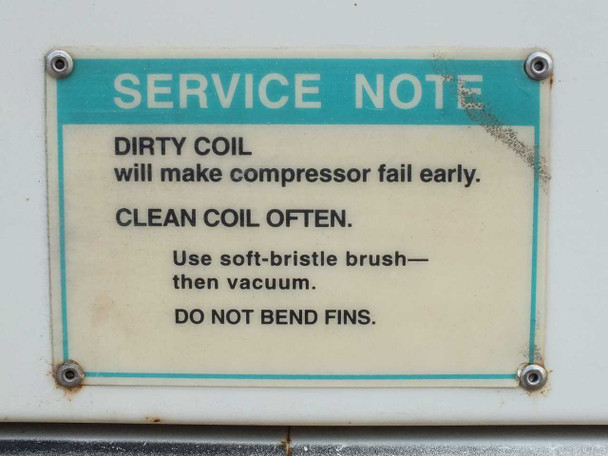 Service note label on chiller — instructs to clean condenser coil often with soft-bristle brush to prevent compressor failure