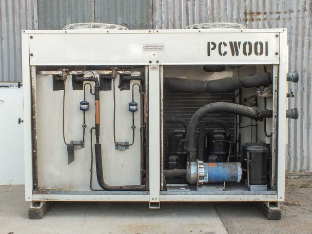 Schreiber 1000AC chiller interior with panel open — showing refrigerant lines, two sight glasses, scroll/reciprocating compressor with blue motor, and large flex duct