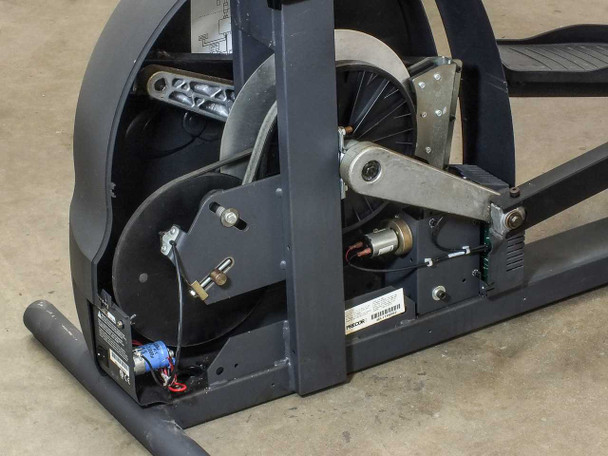 Precor EFX 5.17 drive mechanism — flywheel cover removed, showing flywheel, crank arm, drive belt, and servo motor