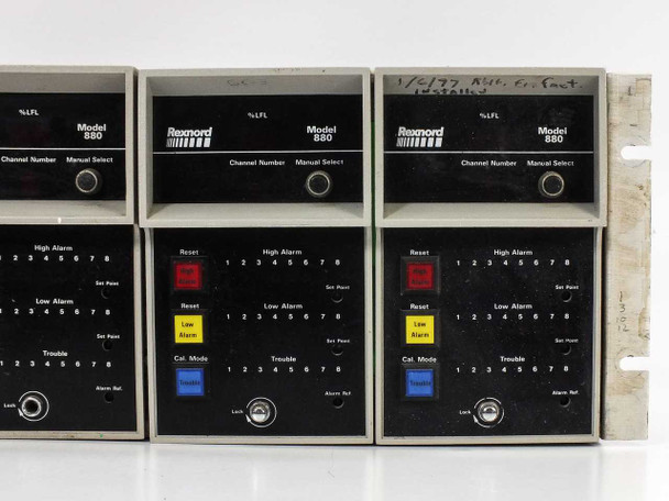 Det Tronics Rexnord Model 880 gas monitor modules – top row showing three units with %LFL display, channel number and manual select knobs; handwritten notation visible on rack frame