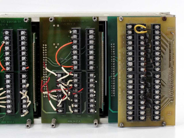 Det Tronics Model 880 monitor board close-up – part number 226138-01 AW Rev B, terminal blocks TB1 through TB5, red and black wiring, and rightmost backplane/interface board visible