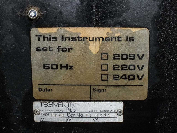 Tegimenta AG internal voltage selector label showing 208V selected, 60Hz, Swiss manufacture plate with Type RC70 and serial number