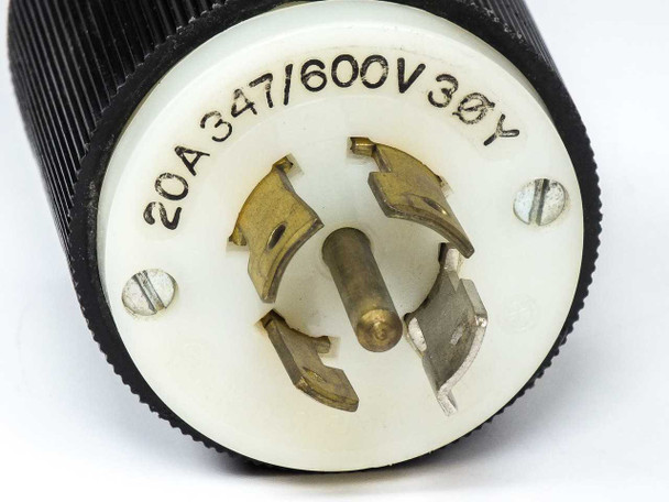 Hubbell 231A NEMA L20-20P plug – front face close-up showing three brass blades and ground pin with 20A 347/600V 3ØY rating molded into white face