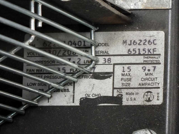 Close-up of refrigerant pressure gauge labeled REGAL R-22 / R-12 / R-502, U.S. Gauge 37921, mounted inside compressor compartment