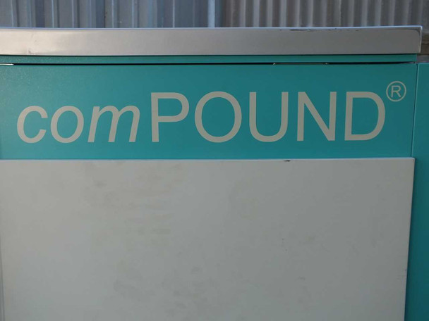 Close-up of comPOUND registered trademark branding on teal freezer cabinet panel