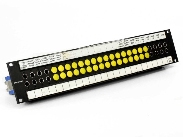 Canare DVJ-W 24-port dual video patchbay front panel — angled view showing yellow normalled buttons and labeled port assignments on a single unit