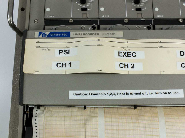 Graphtec WR3320 Linearcorder WR3310 nameplate close-up with caution label reading 'Channels 1,2,3, Heat is turned off, i.e. turn on to use'