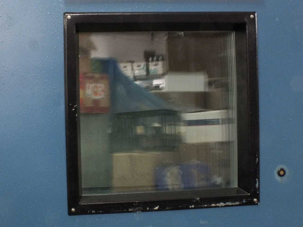 Close-up of Thermotron SM-16-SL chamber door viewport window with reinforced glass panel