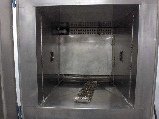 Thermotron SM-16-SL stainless steel inner chamber interior showing side ports, perforated diffuser panels, and test fixture rack on chamber floor