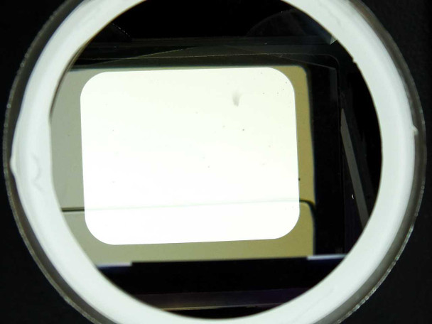Hughes Elcan Prism Assembly – front-on view of circular output aperture showing internal rectangular prism element and white border ring