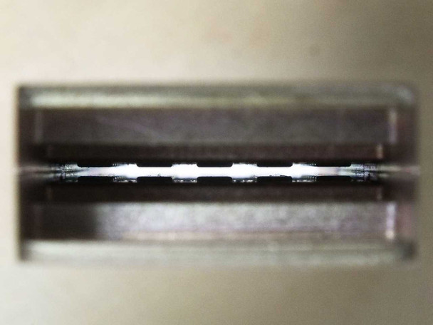 Varian F137CA2 WR-137 waveguide — macro close-up inside the rectangular waveguide aperture showing interior bore and internal pin/probe detail