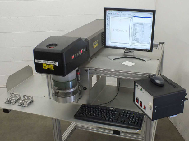Synrad Fenix Flyer 25W CO2 Laser Marker full system front-right view with Dell monitor running WinMark Pro, keyboard, control box, and two workholding fixtures on workstand