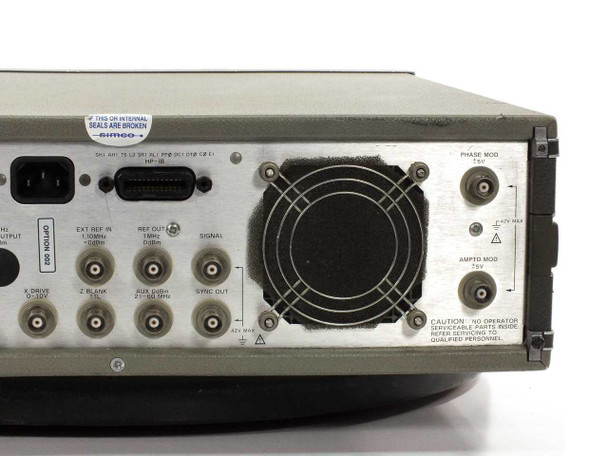 HP 3325A rear panel close-up showing Option 002 PHASE MOD and AMPTO MOD BNC connectors, cooling fan, and SIMCO calibration seal