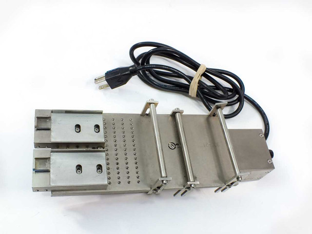 US Vibra 2028-A linear vibratory feeder – top view showing perforated stainless deck, side guide rails, adjustment rods, and attached 3-prong power cord