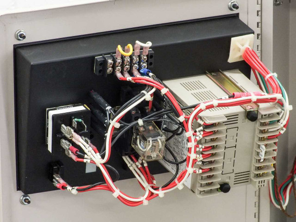 Interior close-up of AEC TDWF7M09S4 showing relay module assembly, control wiring, and DIN-rail mounted components on left cabinet panel