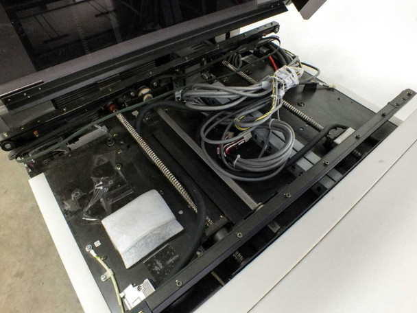 Interior view with top cover open showing ribbon cables, wiring harnesses, actuator mechanisms, and component sequencing tracks