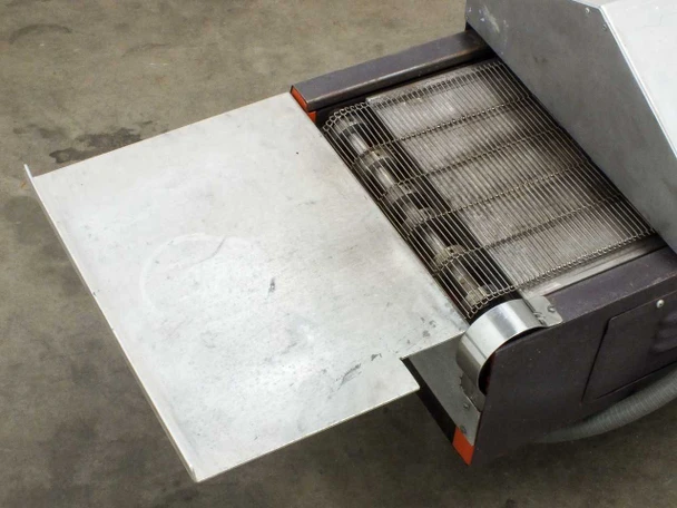 Glo-Quartz TR91-12A – exit end showing stainless steel mesh conveyor belt and unload tray