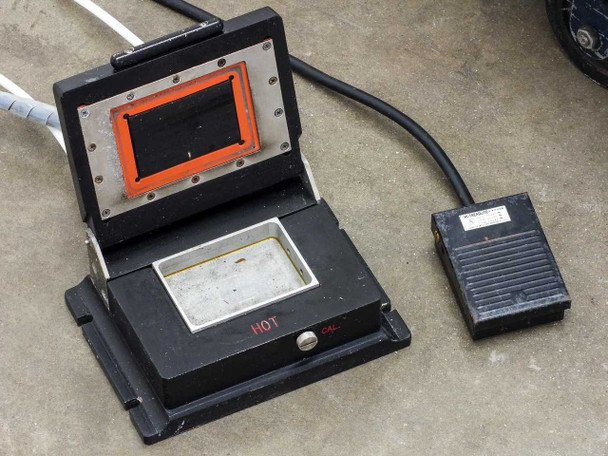 Web Technology 7200 test chamber open showing heated platen with orange gasket seal and foot pedal controller