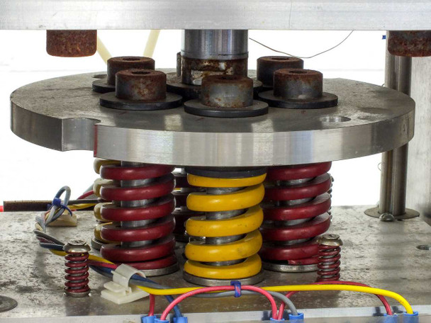 Custom heated pneumatic press on work table – three-quarter front view with power cable coiled on table surface