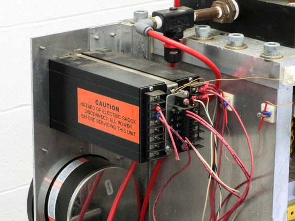 Right-side view of custom heated pneumatic press on work table showing press frame and top-mounted pneumatic cylinder