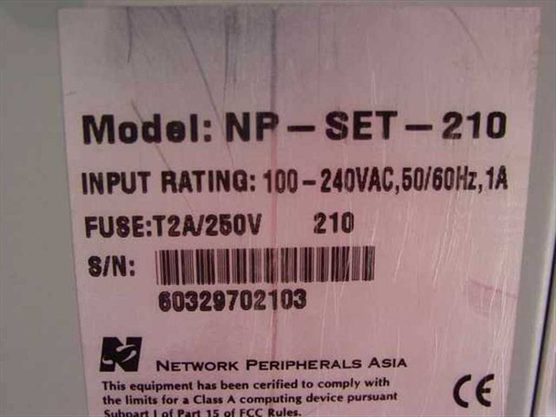 Network Peripherals NP-SET-210 — bottom label showing model number, input rating 100-240VAC 50/60Hz 1A, fuse T2A/250V, serial number barcode, and FCC/CE compliance