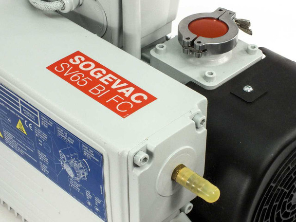 Close-up of SOGEVAC SV65 BI FC model label on pump body with red/white branding, gas ballast valve, and vacuum inlet port with red cap