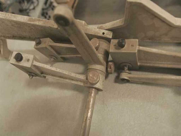 Kodak Versamat Model 11C Roll Feed Adapter — close-up of adjustable rod clamp and pivot hardware mechanism