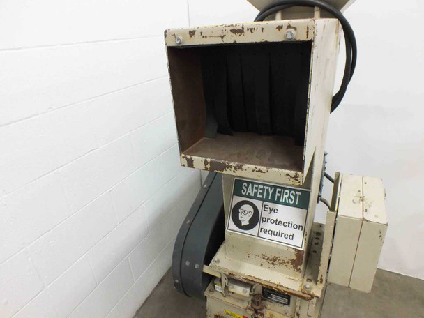 Ball & Jewell BP18 granulator — front view of open side feed throat with Safety First eye protection label and belt guard below