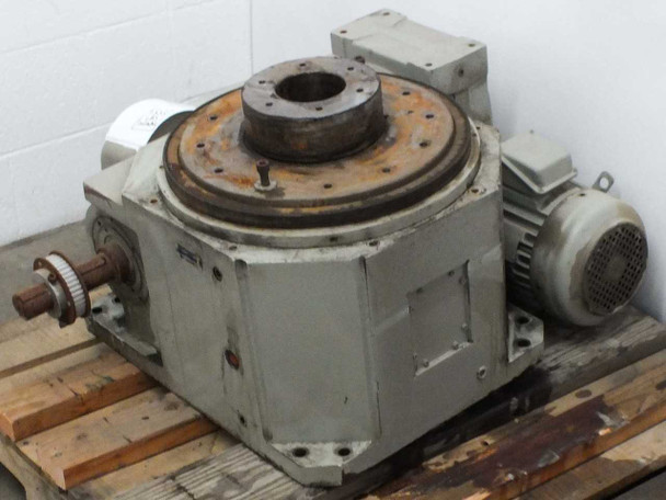 Indexing drive table 25.180.1SRBH2 rear-right view showing output flange with rust, motor housing, and auxiliary shaft on pallet