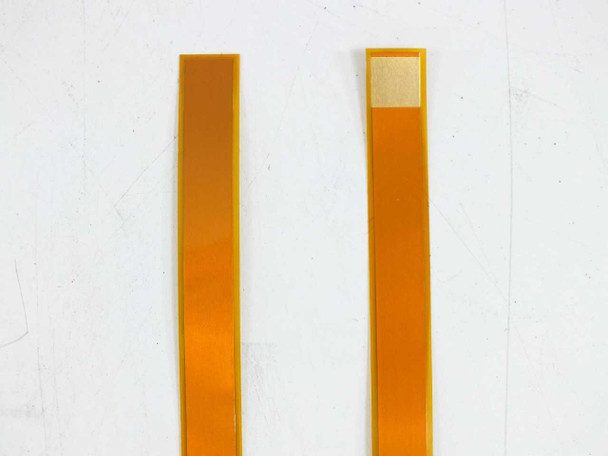 Two individual Flexible Circuit 201878-001 bypass diode ribbons shown full length side by side — amber polyimide flex substrate with gold contact pads
