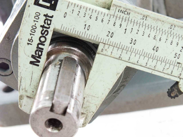 Closer caliper measurement of indexing drive output shaft end confirming 0.75-inch diameter with threaded bore