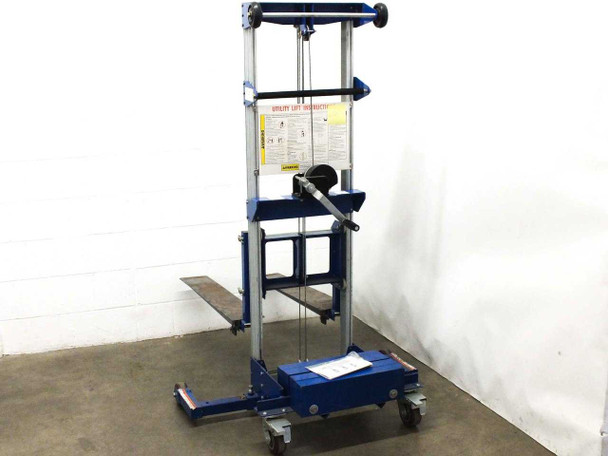 Vestil GL4-BC hand crank stacker – front view showing safety instruction placard, winch handle, mast assembly, and caster wheels
