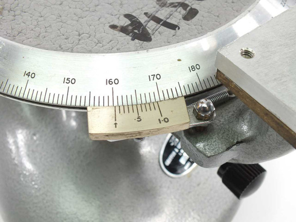 Close-up of the divided circle vernier scale on Griffin & George rotary measuring stage showing degree graduations 140–180 and vernier subinterval markings