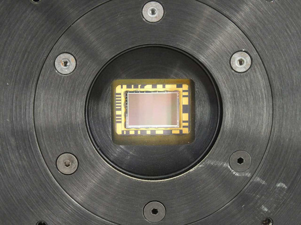 Close-up of Photometrics CH220 CCD image sensor chip mounted in circular black housing showing gold-wire bonded sensor die