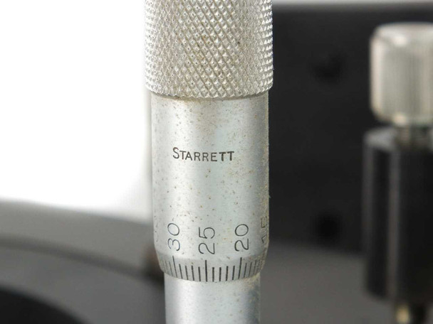 Close-up of Starrett-branded micrometer barrel showing graduated scale markings on the Newport 760 stand