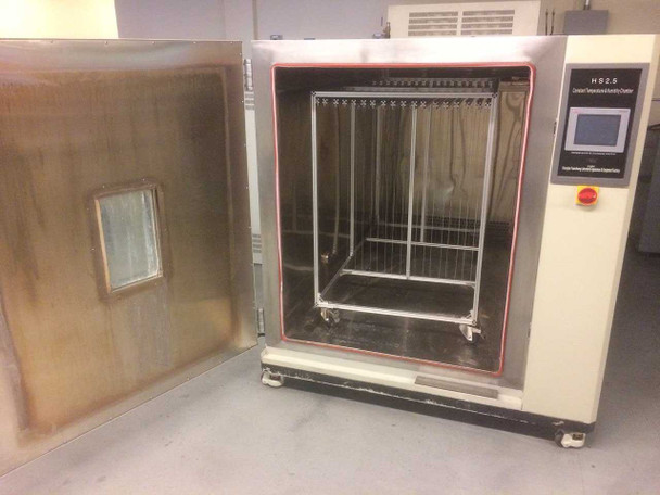Shanghai HS2.5 chamber interior — door open showing stainless steel walls, removable wire mesh shelving rack on wheels, and door-mounted observation window