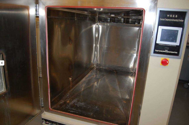 Shanghai HS2.5 chamber interior — close-up of stainless steel floor and walls showing water staining and residue deposits, red door seal gasket visible