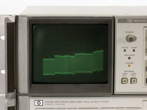 HP 8566B CRT display close-up showing active green phosphor spectrum trace, 100Hz–22GHz label visible on bezel