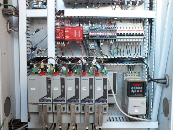 Allen-Bradley control cabinet lower section – multiple PowerFlex VFD drives, safety relay module, and wiring harnesses