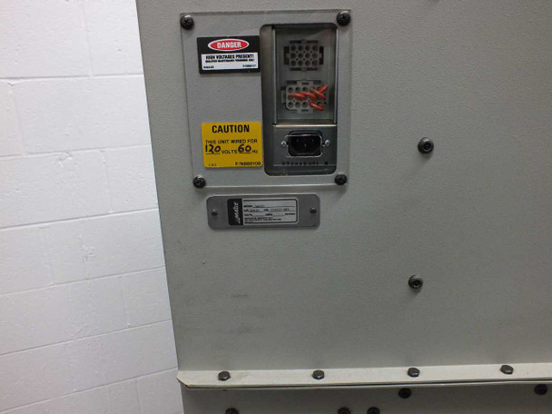 Rimage 5661C rear panel detail — CAUTION label reading 120V 60Hz power requirement, DB-9 serial interface connector, multi-pin connector block behind red safety cover, and Rimage model/serial number data plate