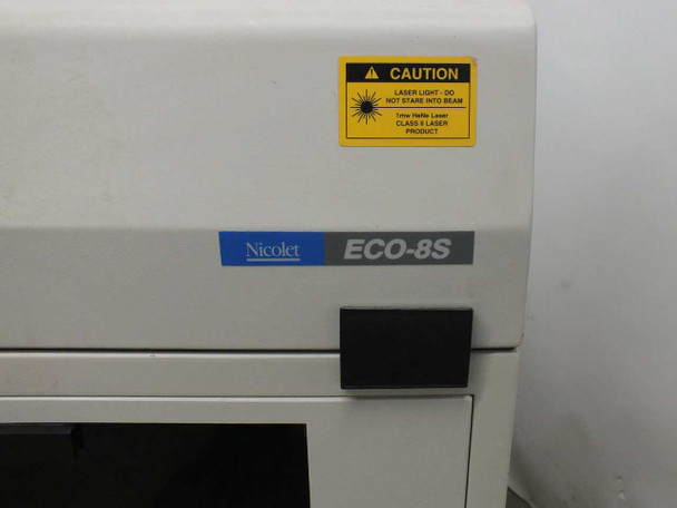 Nicolet ECO-8S nameplate close-up with yellow CAUTION Class 3 Laser Product warning sticker on front panel