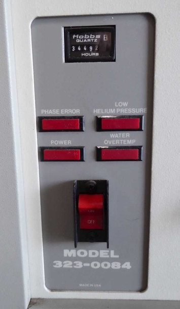 Ebara CryoCompressor 4.8 front control panel detail showing Hobbs quartz hour meter reading 34492 hours, Phase Error, Power, Low Helium Pressure, Water Overtemp indicator lights, ON/OFF rocker switch, and MODEL 323-0084 designation