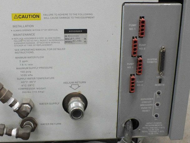 Ebara CryoCompressor 4.8 rear panel detail showing caution/installation label, adsorber sticker, water supply and helium return fittings, pump terminal blocks, system remote connector, expander circuit breaker, and input power requirements label