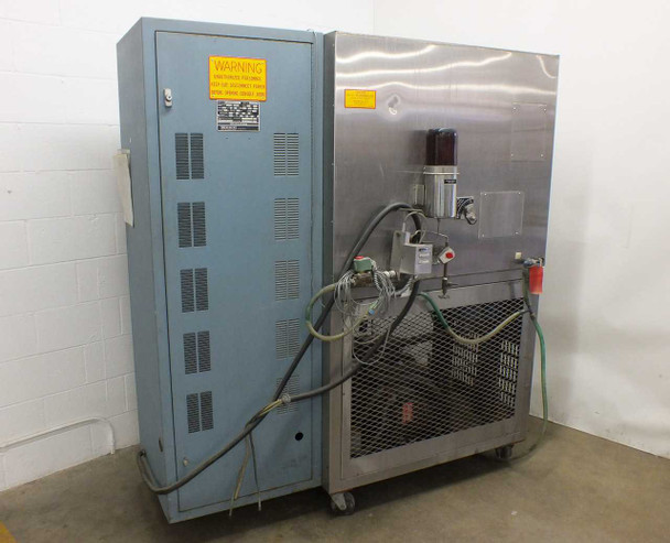 Blue M FR-256PB-1 rear view — blue control cabinet (left) with warning label, rear of chamber (right) showing cylindrical humidifier water supply, solenoid valves, green water supply tubing, and red emergency stop button, unit on casters