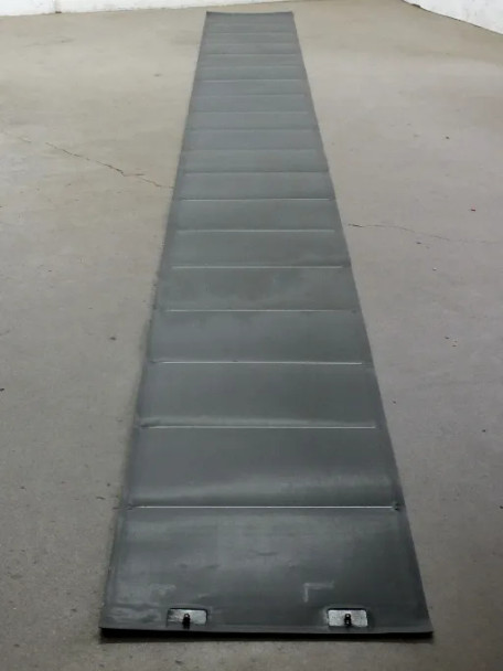 Xunlight XRS19-158 158W flexible solar panel laid flat unrolled showing full length and J-Box connectors at one end