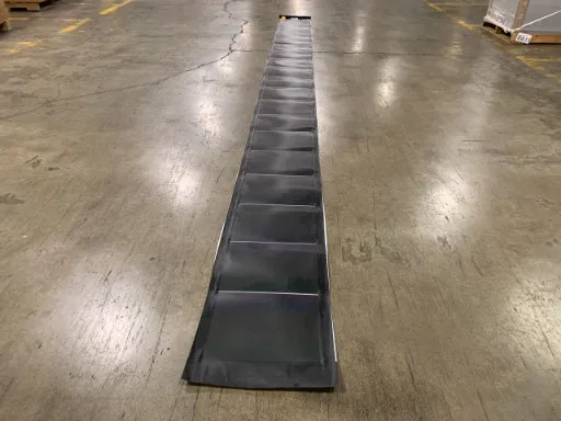 Xunlight XRS19-158 flexible amorphous solar panel laid full length on warehouse floor — alternate angle showing 19 cells